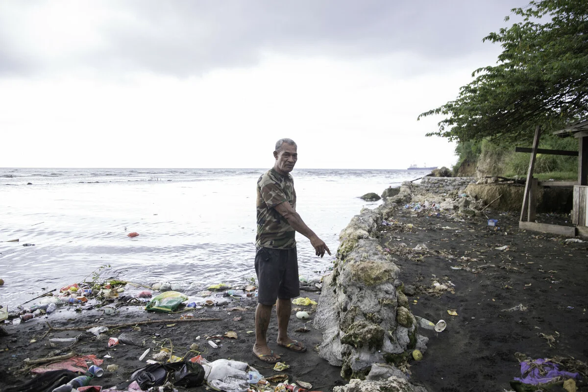 Solomon Islands: Harry Tamateika, who lives along the Mataniko River near Honiara has seen the river rise in the 20 years he has lived alongside it. Harry built this sea wall to keep the water out but it floods during high tides. Oxfam acknowledges the support of the Australian Government through the Australian NGO Cooperation Program (ANCP). Photo: Collin Leafasia/Oxfam.