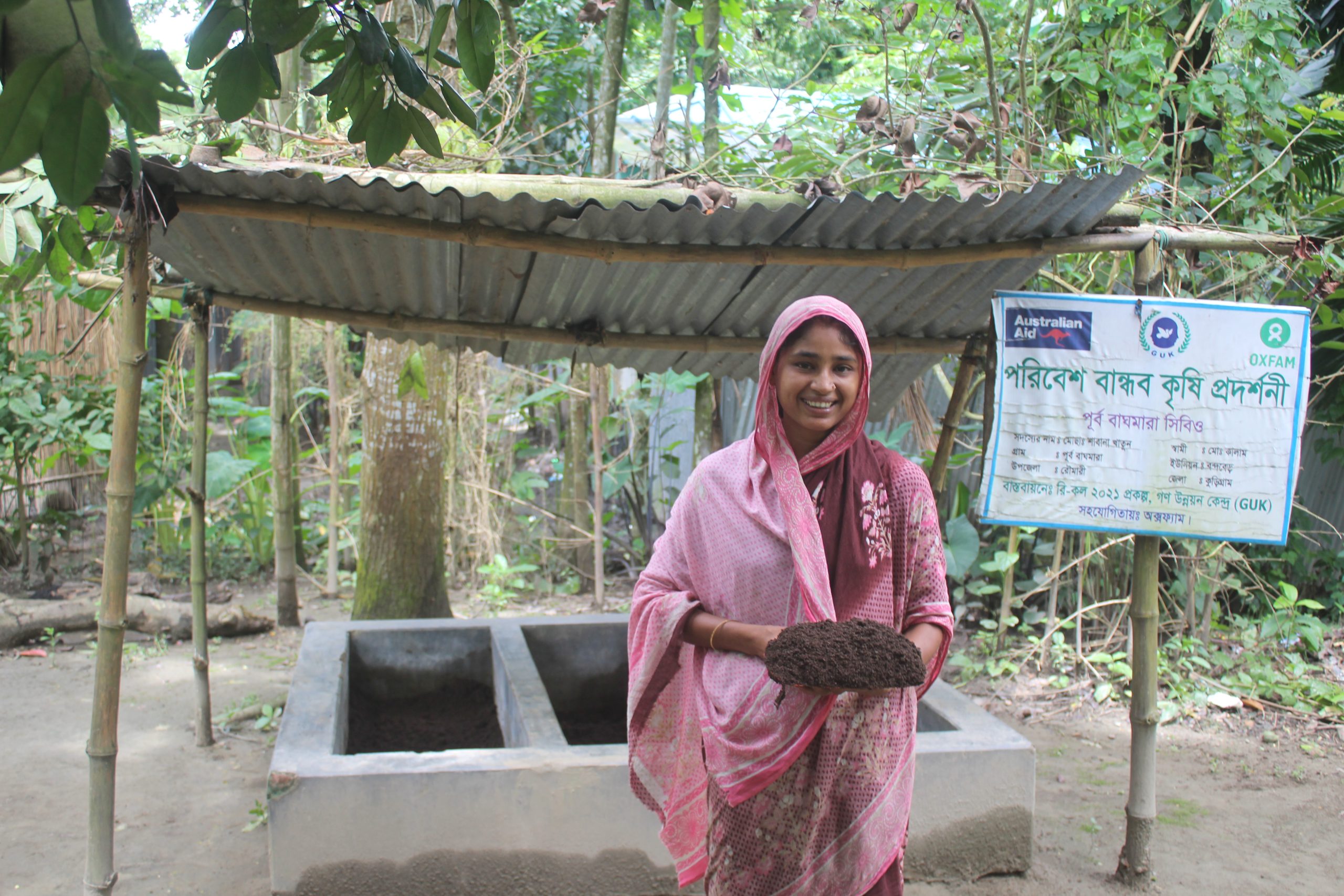 Kurigram, Bangladesh: Shabana stands in front of her compost plant, proudly displaying the fertiliser she produced. Photo: Munir Hossain/Oxfam.