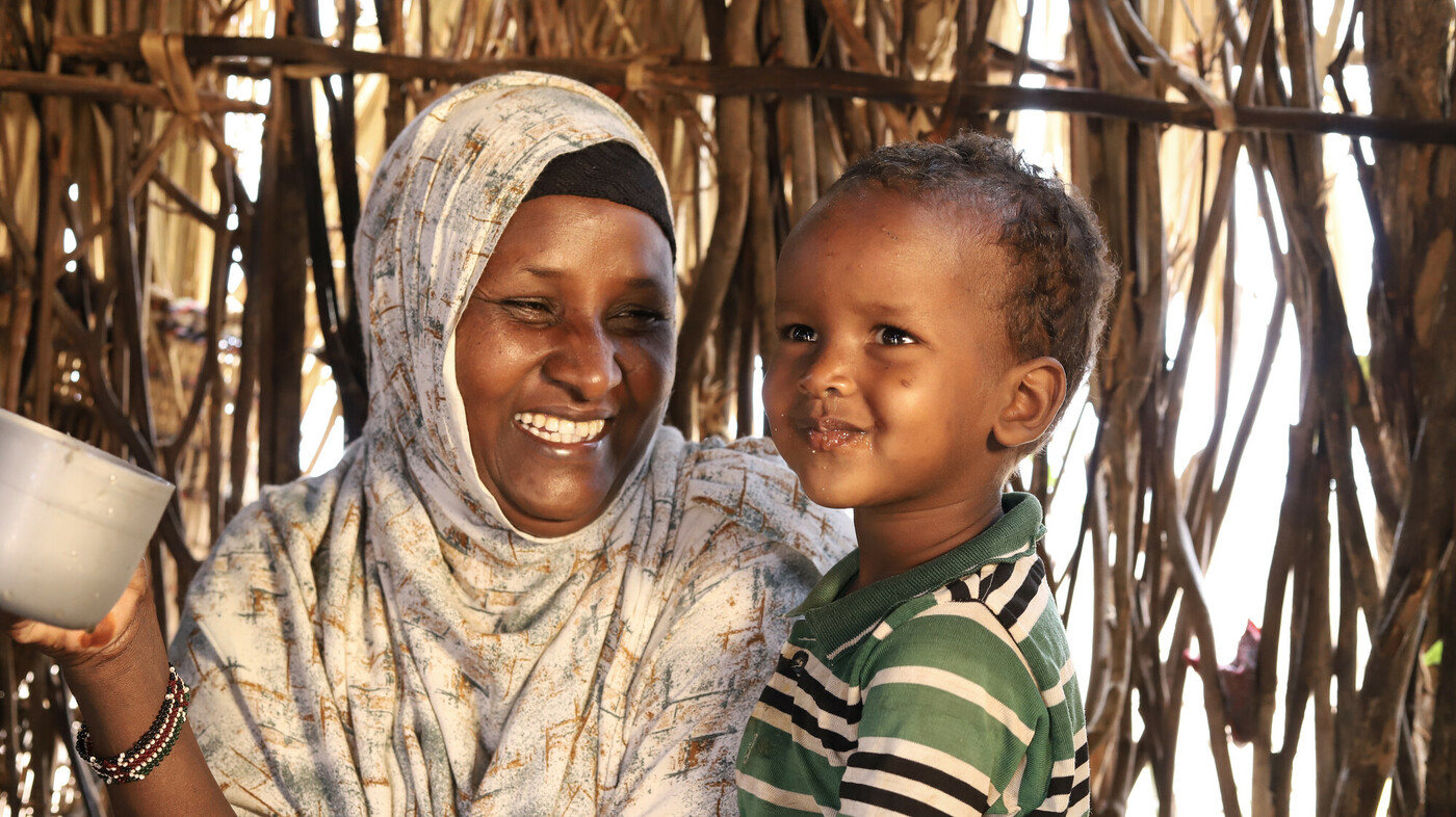 Kenya: Abdia Ibrahim, program participant of the water project in Barambale in Isiolo county where a water point was set up by MID -P in partnership with Oxfam drinks tea with her son. Photo: Eyeris Communications/Oxfam