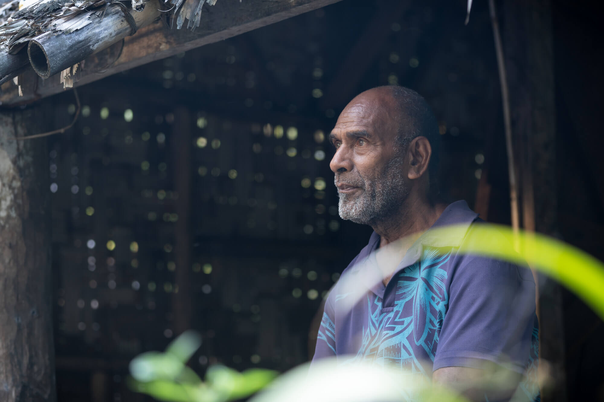 Molpoe, Vanuatu: Roy looks over his village of Molpoe in Vanuatu. In 2022, Molpoe was hit by a devastating landslide caused by torrential rain, which has become more frequent due to extreme weather. Oxfam acknowledges the support of the Australian Government through the Australian NGO Cooperation Program (ANCP). Photo: Ivan Utahenua/Oxfam