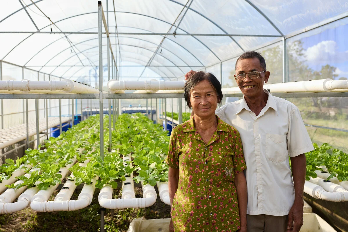 Cambodia: Bun and Vantha (both 60s) are part of an Aquaponics pilot project in their village. The pilot gives local villagers the opportunity to grow vegetables in a climate resilient way that can then be used to support their household expenses. Photo: Patrick Moran/Oxfam