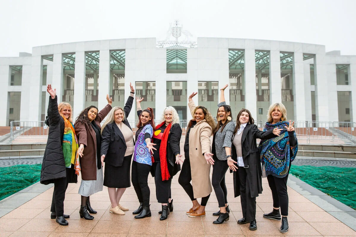 Australia: Canberra, Australia: Straight Talk delegates and facilitator from Victoria pictured in front of the Australian Parliament House the during the 2022 Straight Talk National Summit. Photo: Jillian Mundy/Oxfam