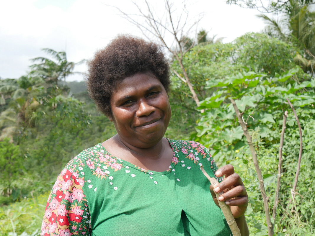 Vanuatu: Nelly Nowa (30), a farmer in rural Lapmuman village on Tanna Island, Vanuatu, stands in her garden. She has participated in workshops run by Oxfam partner, Farm Support Association, and learned climate adaptation techniques to increase her yield. Photo: Rachel Schaevitz/Oxfam