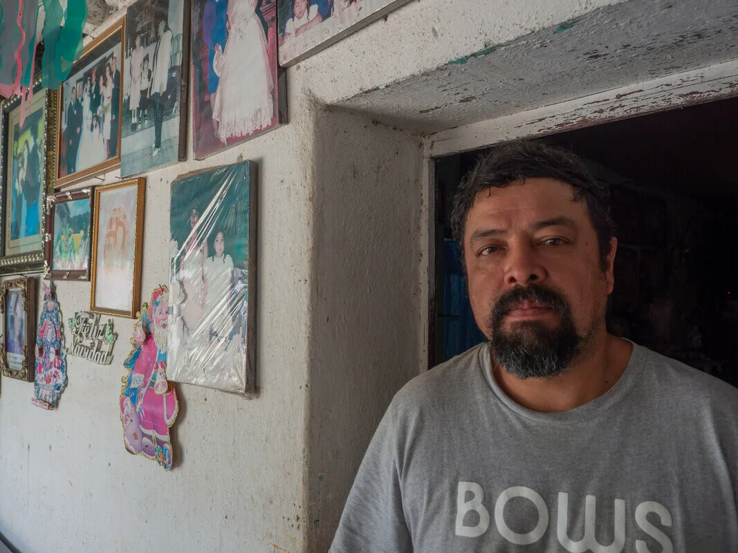 Guatemala: Alexander Reynoso Bran with photos of his daughter. She was an anti-mine activist who was assassinated when she was 16. Reynoso was badly injured in the attack. Photo: Elizabeth Stevens/Oxfam