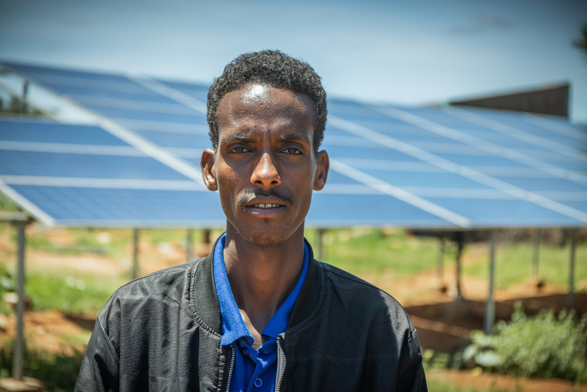 Ethiopia: Mohammud, 27, water bureau head in Ararso says, standing next to the 56-panel solar array that Oxfam installed and now powers the system. Photo: Petterik Wiggers / Oxfam