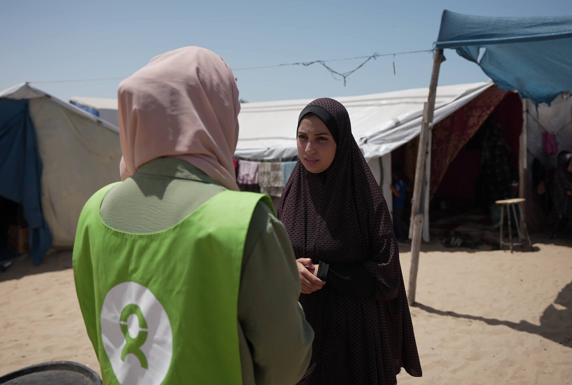 Gaza, Palestinian Territory, Occupied: Ghada Alhaddad stands in the Al-Mawasi area, collecting notes and reflections from people on the ground. Photo: Alef Multimedia/Oxfam