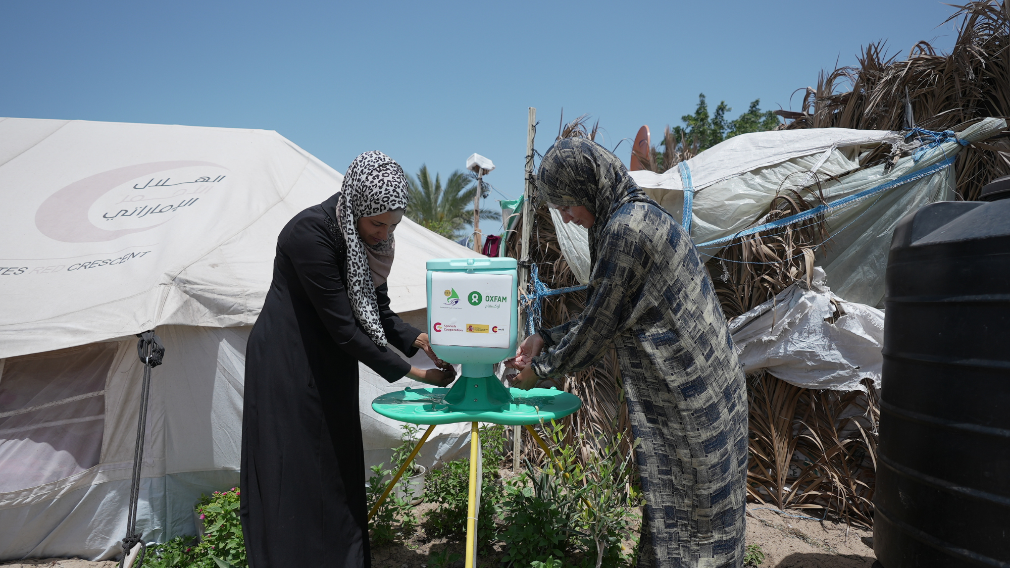 Gaza, Palestinian Territory, Occupied: Some Oxfam community members are washing their hands at the hand washing stations in Al Mawasi Area. Alef Multimedia Company/Oxfam