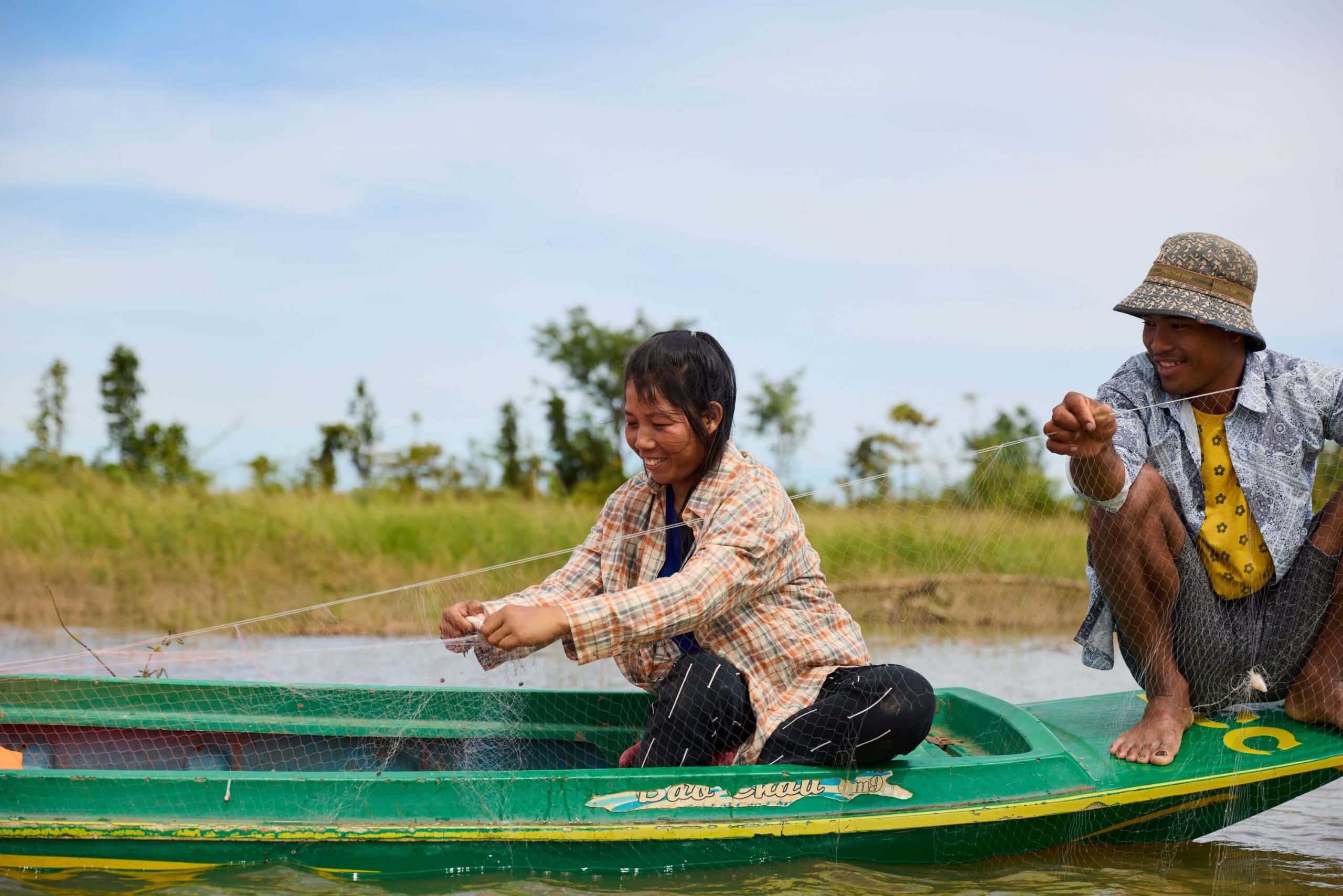 Cambodia: Growing up, Chhorvy and Kneoun used to be able to catch fish from their doorsteps. Since being forcibly relocated due to dam construction, they now have to take the boat out 10km to reach waters for fish. Photo: Patrick Moran/Oxfam. Oxfam acknowledges the support of the Australian Government through the Department of Foreign Affairs and Trade (DFAT).