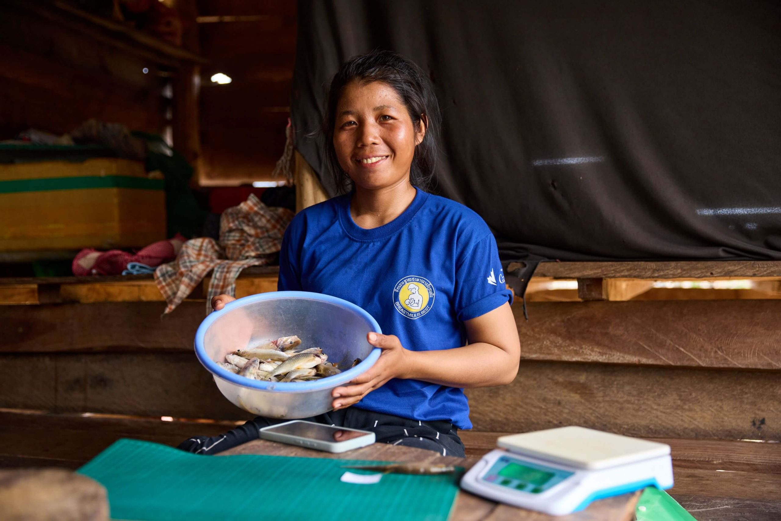 Cambodia: Chhorvy recording her catch for the day. Monitoring the catch of fish is important for the management and conservation of communities who depend on the lake for their nutrition, as well as providing indicators on ecological health of the water due to how sensitive fish are to water changes. Photo: Patrick Moran/Oxfam. Oxfam acknowledges the support of the Australian Government through the Department of Foreign Affairs and Trade (DFAT).